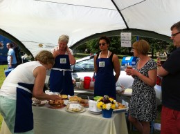 Caroline cutting up more cake..